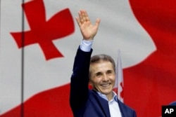 FILE - Bidzina Ivanishvili, leader of the Georgian Dream party, greets demonstrators during a rally for the "foreign influence" law he supports, in Tbilisi, Georgia, on April 29, 2024.