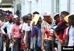 Haitians stand in line as they try to join the country's reformed military in Gressier, Haiti, July 18, 2017.