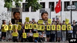 FILE - Activists of Amnesty International stage a protest against the detention of the head of Amnesty International in Turkey, Taner Kılıç, in front of the Turkish Embassy in Berlin, Germany, June 15, 2017.