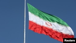 FILE - The Iranian flag flies over a street in Tehran, Feb. 3, 2023.
