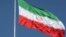 FILE - The Iranian flag is seen flying over a street in Tehran.