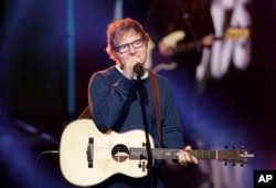FILE - British singer Ed Sheeran performs during the Italian State RAI TV program "Che Tempo che Fa", in Milan, Italy, March 12, 2017.