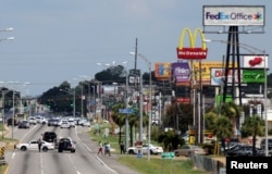 Police vehicles block access to part of Airline Highway after a fatal shooting of police officers in Baton Rouge, Louisiana; Sunday July 17, 2016.