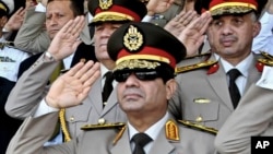 FILE - In this July 22, 2013, file photo released by the Egyptian Presidency, Defense Minister Gen. Abdel-Fattah el-Sissi, listens to the national anthem during a medal ceremony at a military base east of Cairo