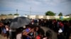 Mainly Haitian along with some African migrants wait in men's and women's lines to request documents giving them temporary legal status in Mexico, outside the Siglo XXI detention center in Tapachula, Mexico, June 12, 2019. 