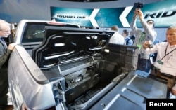 Attendees look over the 2017 Honda Ridgeline after it was unveiled at the North American International Auto Show in Detroit, Jan. 11, 2016.