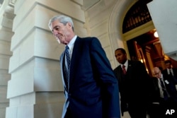 FILE - Former FBI Director Robert Mueller, the special counsel probing Russian interference in the 2016 election, departs Capitol Hill following a closed door meeting in Washington, June 21, 2017. A 2001 Justice Department memo warned that no nation, incl