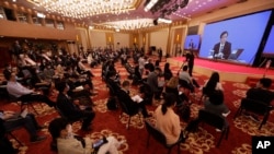 Journalists attend a news conference by Zhang Yesui, a spokesman for the National People's Congress, broadcast remotely to the media center on the eve of the annual legislature opening session in Beijing on Thursday, May 21, 2020.