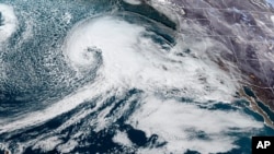 This satellite image made available by NOAA shows a storm system approaching the US West coast on Tuesday, Jan. 3, 2023, at 6:36 p.m. EST. 
