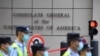 FILE - Policemen walk past the U.S. consulate in Chengdu, southwestern China's Sichuan province, July 26, 2020. Frustation is growing over lagging trade talks between the U.S. and China.