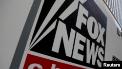 FILE - A Fox News channel sign is seen on a television vehicle outside the News Corporation building in New York City, Nov. 8, 2017. 