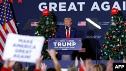 Former US President and 2024 presidential hopeful Donald Trump speaks during a campaign event in Waterloo, Iowa, on Dec. 19, 2023.