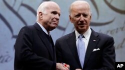 Sen. John McCain, R-Ariz., receives the Liberty Medal from Chair of the National Constitution Center's Board of Trustees, former Vice President Joe Biden in Philadelphia, Monday, Oct. 16, 2017. 