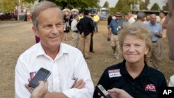In this Thursday, Aug. 16, 2012 photograph, Rep. Todd Akin, R-Mo., and his wife Lulli, talk with reporters while attending the Governor's Ham Breakfast at the Missouri State Fair in Sedalia, Mo. 