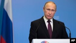 FILE - Russian President Vladimir Putin delivers his speech attending the World Health Organization ministerial conference in Moscow, Nov. 16, 2017. 