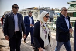 Egypt's Health Minister Hala Zayed inspects moored river boats along the coast of the Nile in the southern city of Luxor on March 8, 2020. - Egypt's health ministry said the 45 detected cases would be quarantined even though 11 of them had tested…