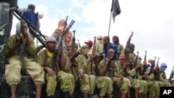 FILE - Al-Shabab fighters sit on a truck as they patrol in Mogadishu, Somalia, Oct. 30, 2009.