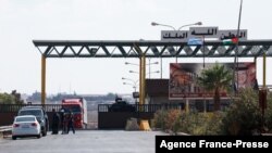 Vehicles enter Syria through the Nassib/Jaber border post with Jordan on the day of its reopening, Sept. 29, 2021, after two months of closure due to fighting in southern Syria.