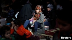 Civilians who escaped from Islamic State militants at Raqqa's front line rest at a mosque in Raqqa, Syria, Oct. 12, 2017. 