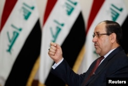 FILE - Iraq's Prime Minister Nuri al-Maliki speaks during an interview with Reuters in Baghdad in 2014..