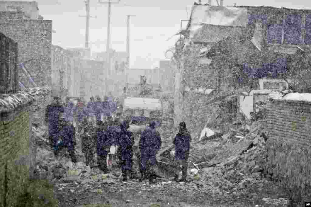 A mock protester throws a water bomb during police exercises to manage civil unrest in Manila, Philippines ahead of a visit by US President Barack Obama.