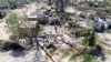 A person stands amid uprooted trees and debris after Cyclone Chido hit the Mecufi district, Cabo Delgado province, Mozambique, Dec. 16, 2024, in this screengrab taken from a handout drone video. 