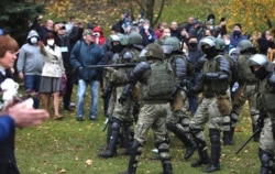 People argue with policemen during an opposition rally to protest the official presidential election results in Minsk, Belarus, Nov. 1, 2020.