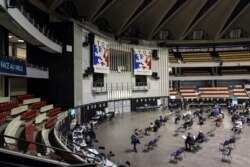 FILE - People wait after receiving the Pfizer-BioNTech vaccine against the COVID-19 in a vaccination center of Lyon, France, Apr. 8, 2021.