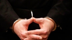 FILE - Convicted mass murderer Anders Behring Breivik's hands are seen in handcuffs as he arrives at a courthouse in Oslo, Aug. 24, 2012