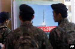 FILE - South Korean army soldiers watch a TV news program with a file footage about North Korea's rocket launch at Seoul Railway Station in Seoul, South Korea, Feb. 7, 2016.