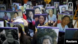 Students hold portraits of deceased former South Korean "comfort women" during a weekly anti-Japan rally in front of the Japanese Embassy in Seoul, South Korea, Dec. 30, 2015.
