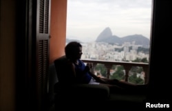 A guest relaxes with the The Sugar Loaf mountain in the background at Pousada Favelinha (Little favela) hostel in Pereira da Silva favela, in Rio de Janeiro, Brazil, April 29, 2016.
