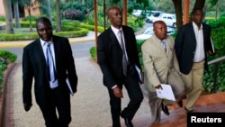 M23 rebel negotiators are seen heading into the final leg of negotiations with the Congolese government, in Kampala October 19, 2013. 