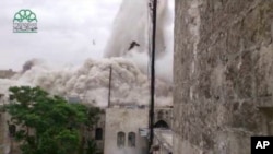 FILE - An explosion that destroyed the Carlton Hotel in Aleppo, Syria.