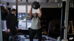 Seorang remaja berlatih olahraga bersama pelatihnya di sebuah pusat kebugaran di Los Angeles pada 13 Maret 2023. (Foto: AP/Jae C. Hong)