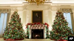 The State Dining Room of the White House is decorated for the holiday season during a press preview of the White House holiday decorations, on Monday, Nov. 29, 2021, in Washington. (AP Photo/Evan Vucci)