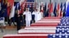 Vice President Mike Pence, left, Commander of U.S. Indo-Pacific Command Adm. Phil Davidson, center, and Rear Adm. Jon Kreitz, deputy director of the POW/MIA Accounting Agency, attend at a ceremony marking the arrival of the remains believed to be of American service members who fell in the Korean War at Joint Base Pearl Harbor-Hickam, Hawaii, Wednesday, Aug. 1, 2018.
