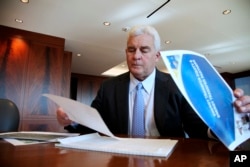 FILE - Energy Transfer Partners CEO Kelcy Warren reviews documents at his office in Dallas, Nov. 18, 2017, on the Dakota Access oil pipeline that is mired in controversy.