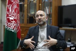 FILE - Afghan National Security Adviser Mohammad Hanif Atmar speaks during an interview with The Associated Press, in Kabul, Afghanistan.
