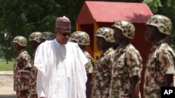 Nigerian President Muhammadu Buhari reviews troops in Maiduguri on Oct. 1, 2017.
