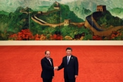 FILE - Egypt's President Abdel Fattah el-Sisi, left, shakes hands with Chinese President Xi Jinping during the Forum on China-Africa Cooperation held at the Great Hall of the People in Beijing, Sept. 3, 2018.