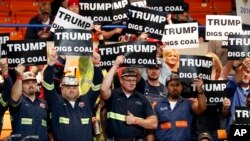 Coal miners, a constituency Democratic presidential contender Hillary Clinton has also been courting, wave Trump signs as they wait for a rally in Charleston, W.Va., May 5, 2016. 
