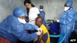 FILE - This handout photo released by Doctors Without Borders (MSF) Nov. 14, 2019, shows a young man receiving an Ebola vaccine at MSF facilities in the North Kivu capital of Goma, DRC. Both Guinea and the DRC are reporting a reemergence of the virus. 