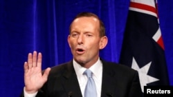 Australia's conservative leader Tony Abbott gestures as he claims victory in Australia's federal election during an election night function in Sydney, Sept. 7, 2013.