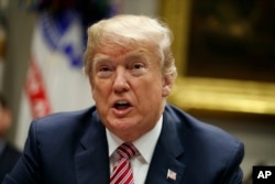 FILE - President Donald Trump speaks during a meeting with state and local officials to discuss school safety, in the Roosevelt Room of the White House, Feb. 22, 2018, in Washington.