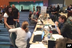 Acting Homeland Secretary Elaine Duke, left, talks to first responders during her visit, Sept. 29, 2017, in Puerto Rico.