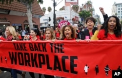 FILE - Participants march against sexual assault and harassment at a #MeToo event in the Hollywood section of Los Angeles, Nov. 12, 2017.