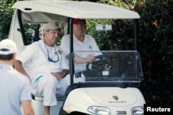 FILE - President Donald Trump arrives to play host to members of the U.S. Coast Guard he invited to play golf at his Trump International Golf Club in West Palm Beach, Fla., Dec. 29, 2017.