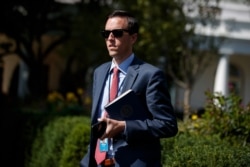 White House deputy press secretary Judd Deere waits for the arrival of President Donald Trump to the White House, Oct. 4, 2019, in Washington.
