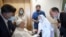 Pope Francis is greeted by a nun as he sits in a wheelchair July 11, 2021, inside the Agostino Gemelli Polyclinic in Rome, where he is recuperating following a July 4, 2021, surgery. (Vatican Media via AP) 
